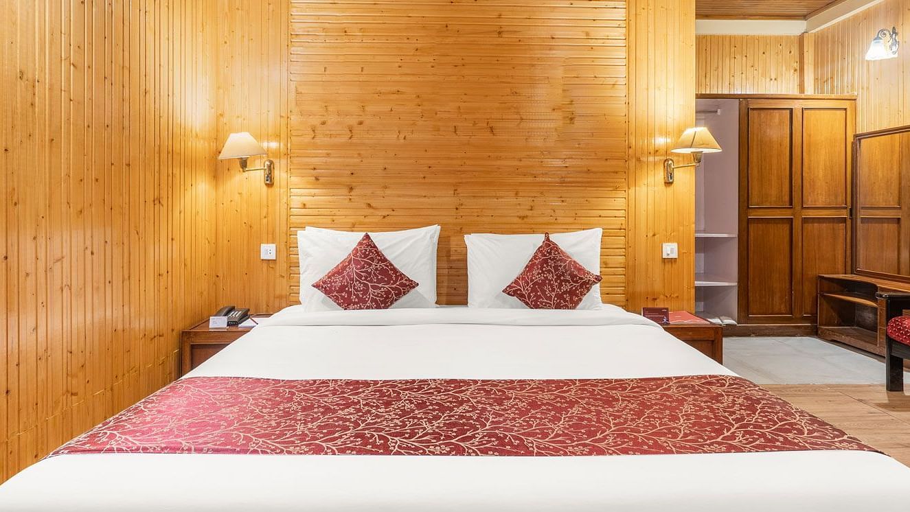 Image of a room with wooden decor and a double bed at at Summit Tashi Ghang Heritage Resort, Pelling
