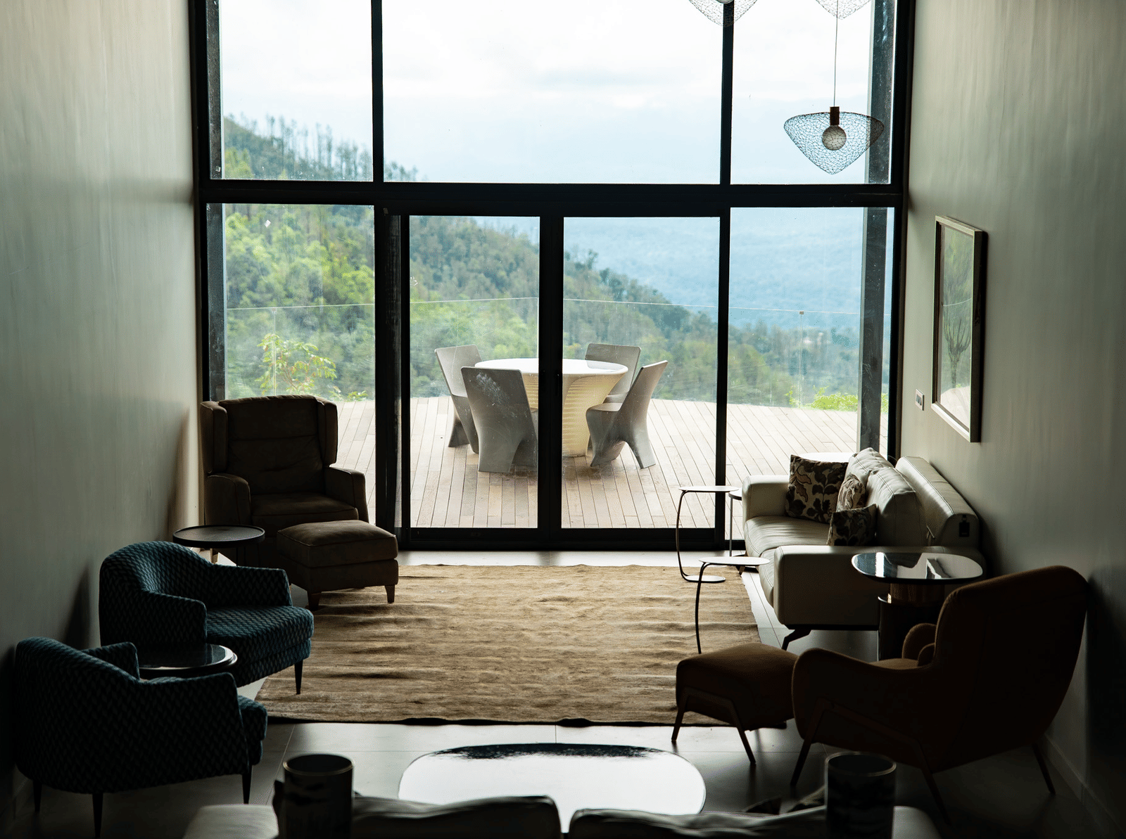 A spacious living room at Stanley Revelation with floor-to-ceiling windows and a view of the mountains.