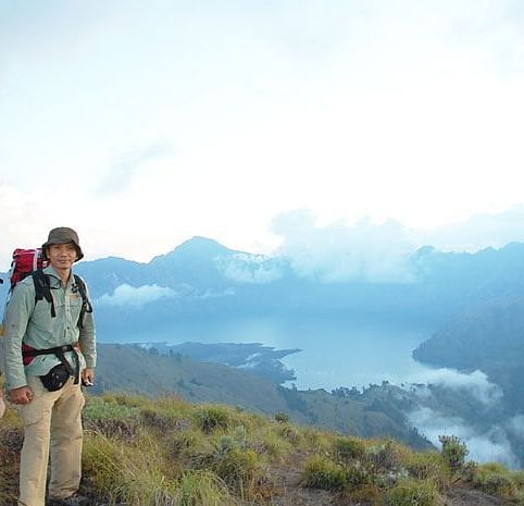 image of two people standing with the mountain background