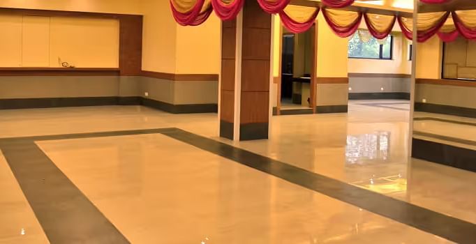 View of banquet hall called The Durbar with polished flooring and ample space for events - Max Hotel Prayagraj.