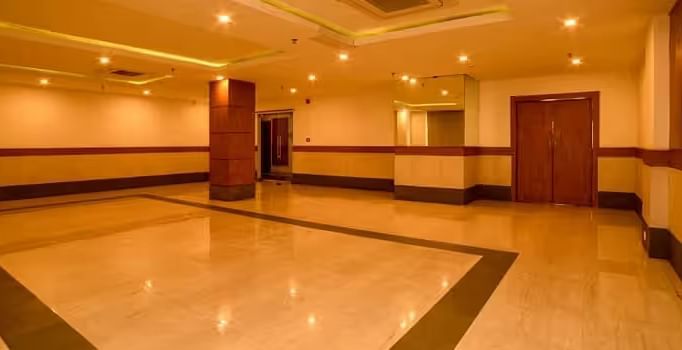 View of banquet hall called The Durbar with polished flooring and ample space for events - Max Hotel Prayagraj.