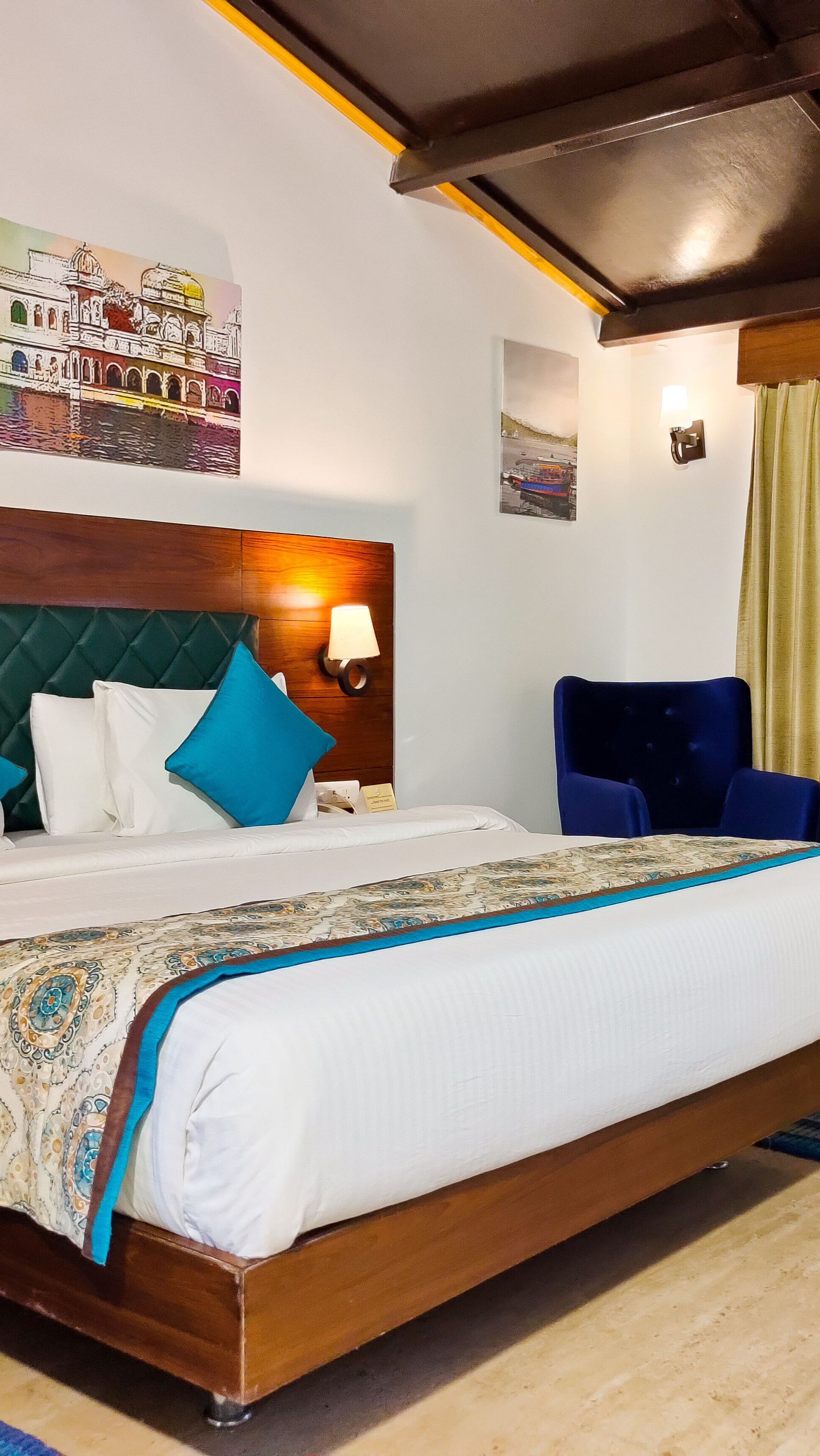 King size bed in regal deluxe with private balcony room at our resort in Udaipur 
