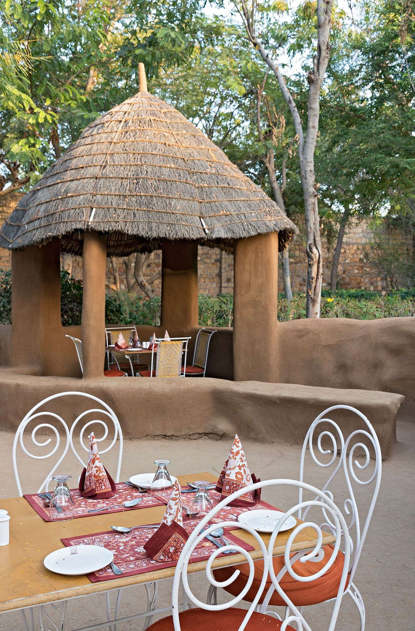 An image of the outdoor seating arrangement of the Taasli Restaurant at Manvar Shergarh - Manvar Resort & Desert Camp