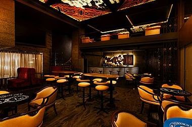 Luxurious fine dining hall with warm lighting and sophisticated interiors at GRT Hotels.