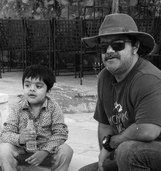 A black and white image of Luv Shekhawat with a toddler