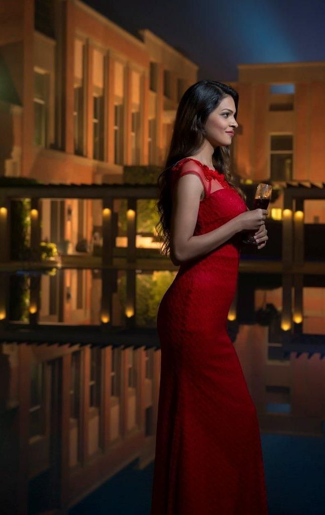 A photo shoot of a woman holding a wine glass at night at Nirvana Luxury Hotel, Ludhiana.