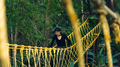 A woman walking on a rope bridge - Black Thunder, Coimbatore