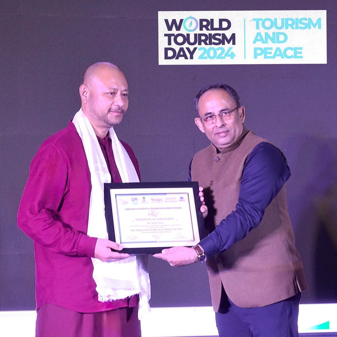 Man receiving an award at World Tourism Day 2024 event.