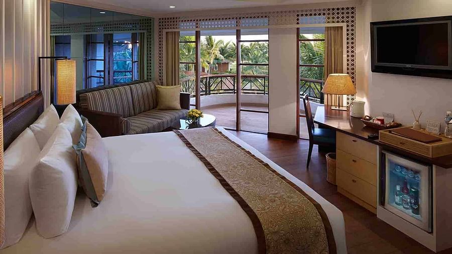 A double bed with a tv opposite it inside the Deluxe-view rooms in South Goa - Caravela Beach Resort, Goa