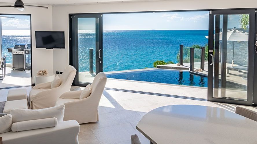 Luxurious living room with panoramic ocean views at Tamarind Hills Antigua – Resort & Villas