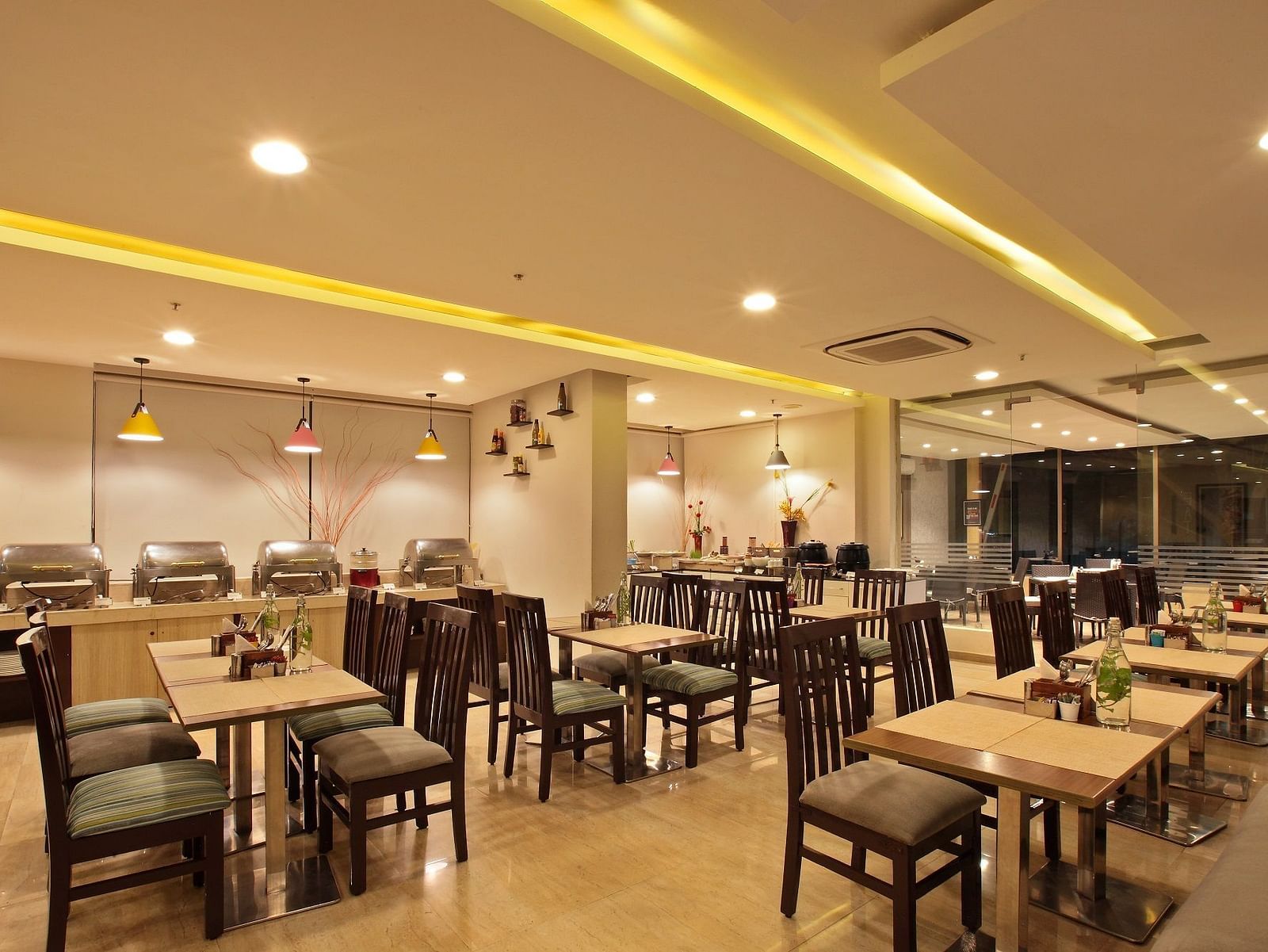 Seating arrangement in the restaurant at Starlit Suites, Bangalore