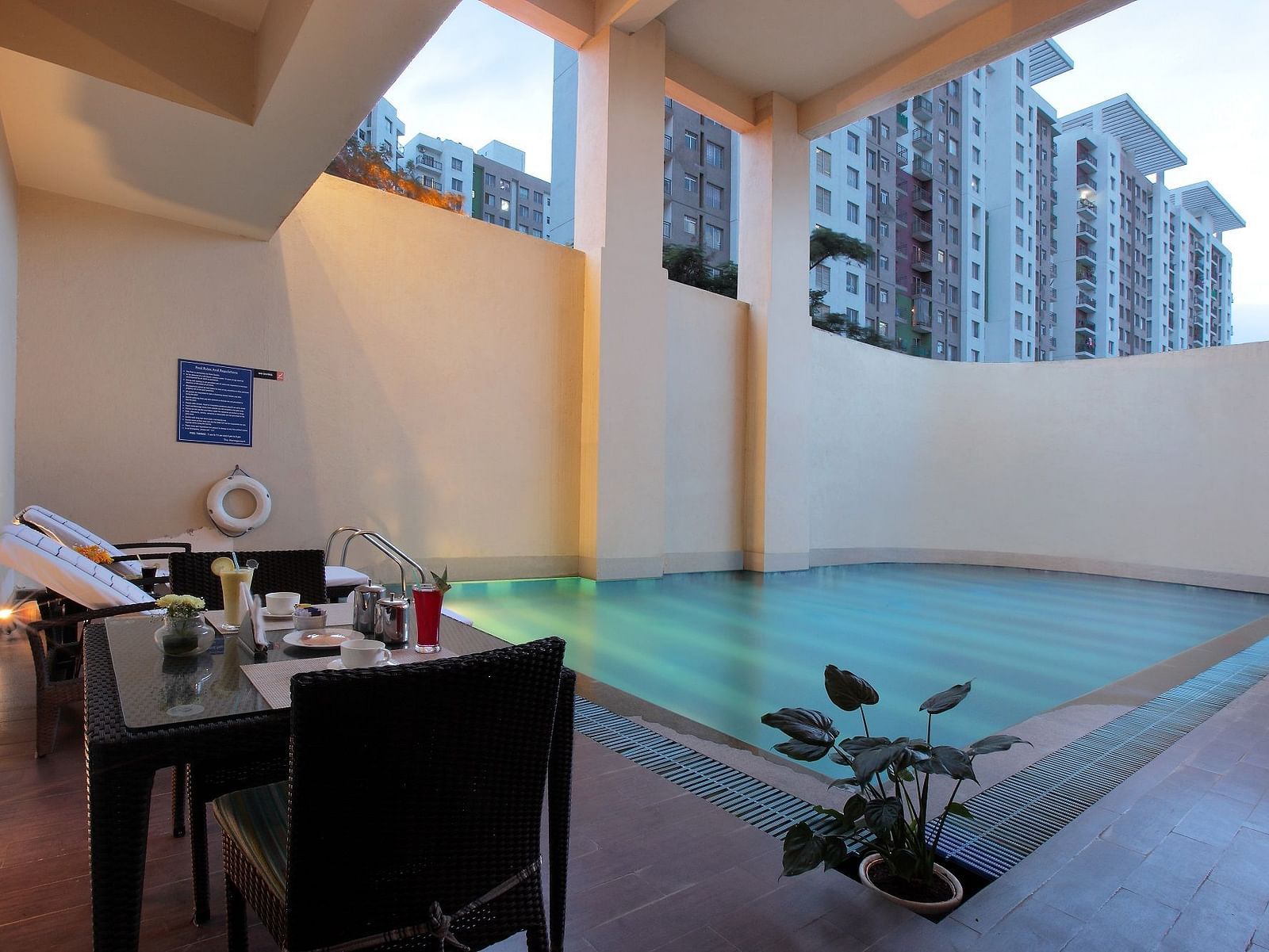 Dining setup besides the swimming pool at Starlit Suites, Bangalore