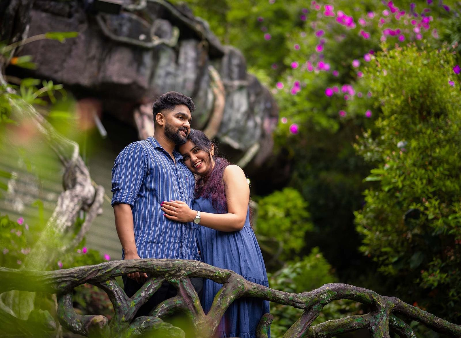 a couple in a scenic place with greenary and violet flowers