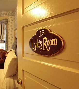 A door to a hotel room with Lyle's Room sign board attached to it - The Groveland Hotel.