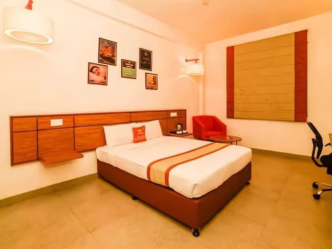 A stylish and cosy hotel room with a king size bed, soft lighting, and contemporary decor - Max Hotel Prayagraj.