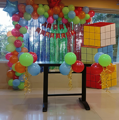 Colourful balloon arch with gift box decorations at Central Hotels event space.