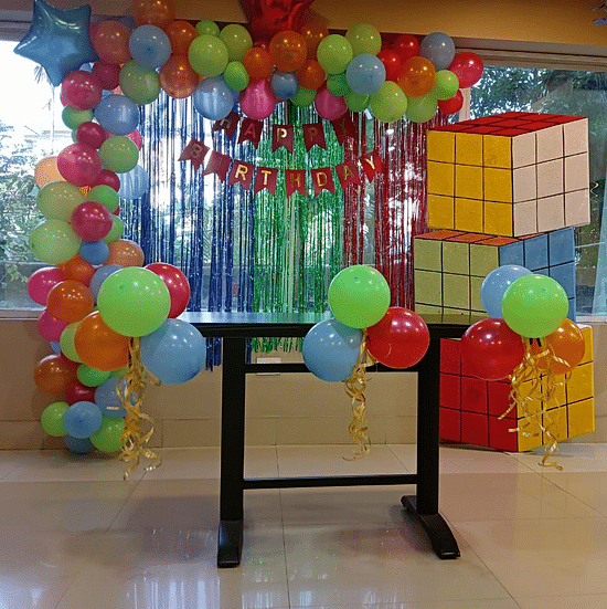 Colourful balloon arch with gift box decorations at Central Hotels event space.