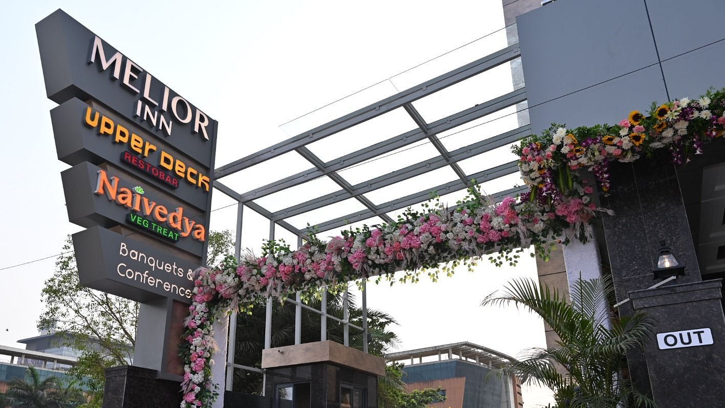 An exterior view of the entrance of Melior Inn with signage and some decoration.