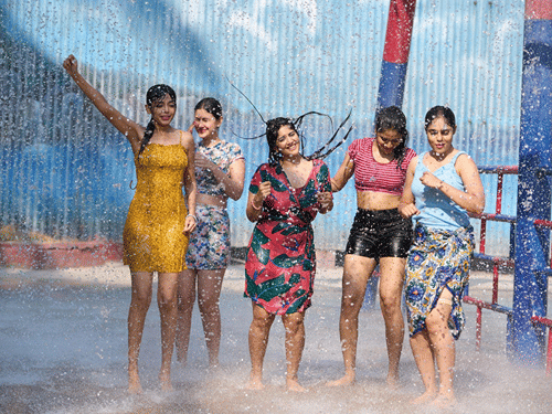 A group of women enjoying a splash zone under mist and water sprays at Black Thunder. Black Thunder is located near Kallar, a stop in the Mettupalayam to Ooty Toy Train.