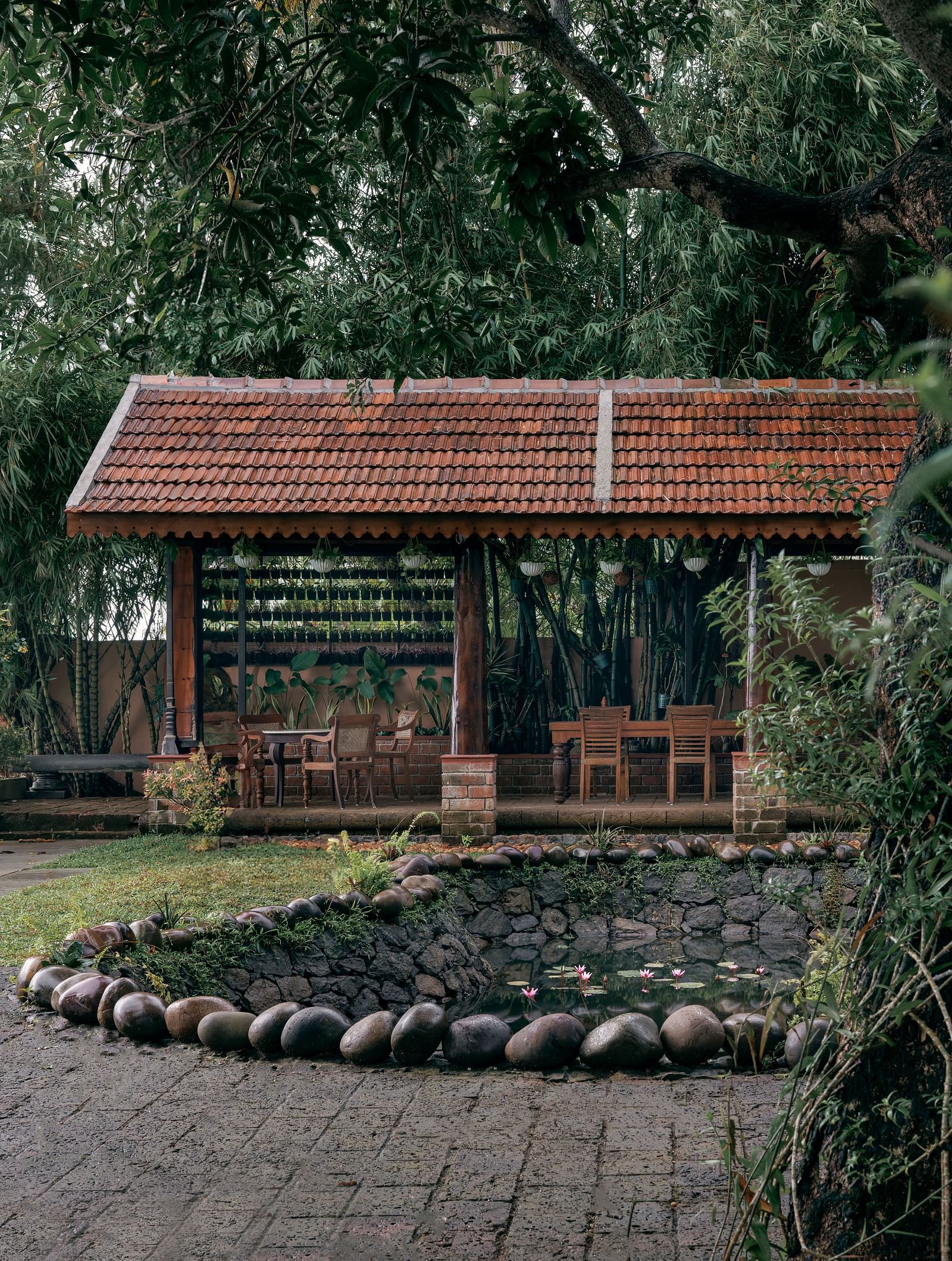 A facade image showcasing the pond at BluSalzz Villas - Muhamma Resort, Alleppey and the outdoor seating area of the restaurant