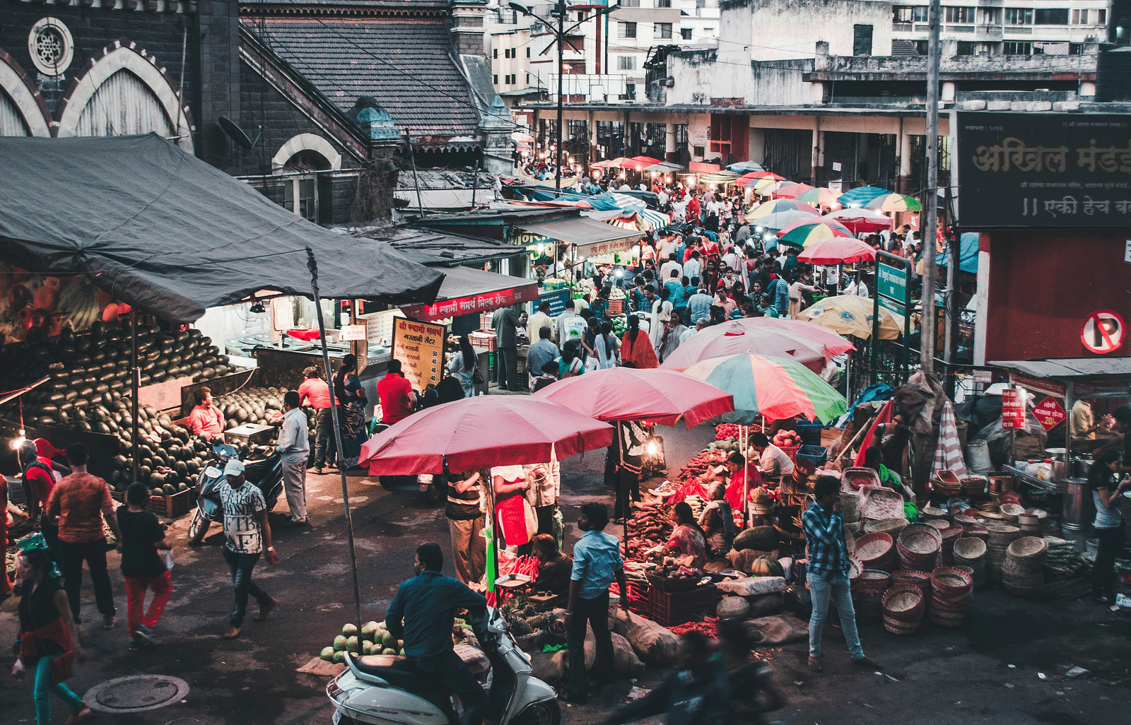 A view of evening market with a lot of shops and people.