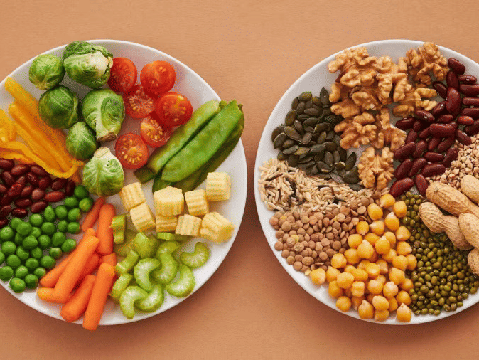 A couple of plates filled with various vegetables and dry fruits on a beige surface