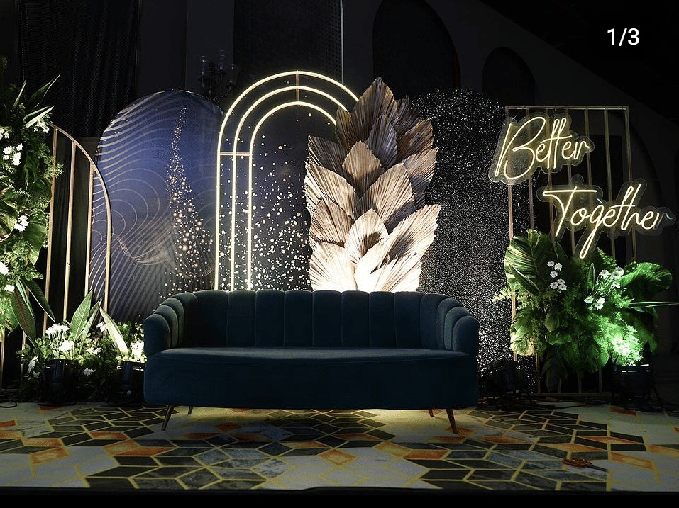 A Modern indoor decor setup with floral backdrop and seating area at Gulmohar Garden of Papaya Tree Hotels, ideal for pre-wedding or reception functions.