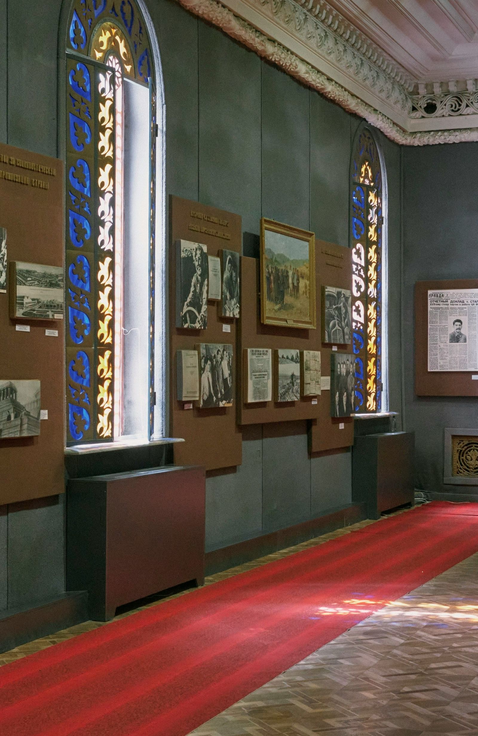 An image of a museum featuring several photographs and frames on the wall