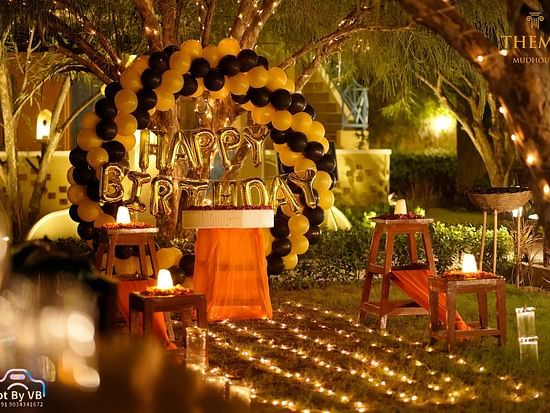 A well-decorated lawn decked with fairy lights and balloons at Themis Mudhouse - A Nature's Retreat Resort & Wellness