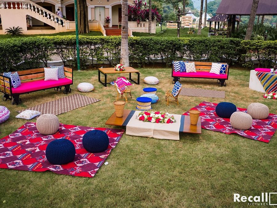Casual outdoor seating area on a lawn, featuring colourful cushions, low tables, and a relaxed bohemian theme - Black Thunder, Coimbatore
