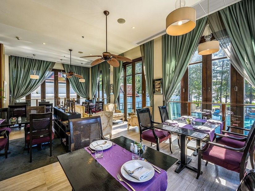 image of the indoor restaurant with chic interiors overlooking the swimming pool from the windows - Maikhao Dream Villa Resort & Spa, Phuket