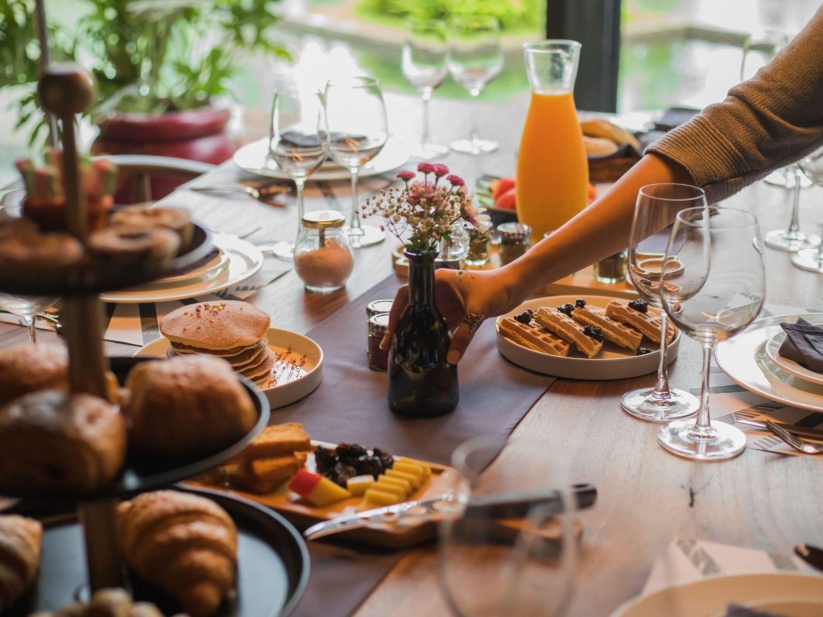 Picture featuring a dining table with a lot of dishes arranged