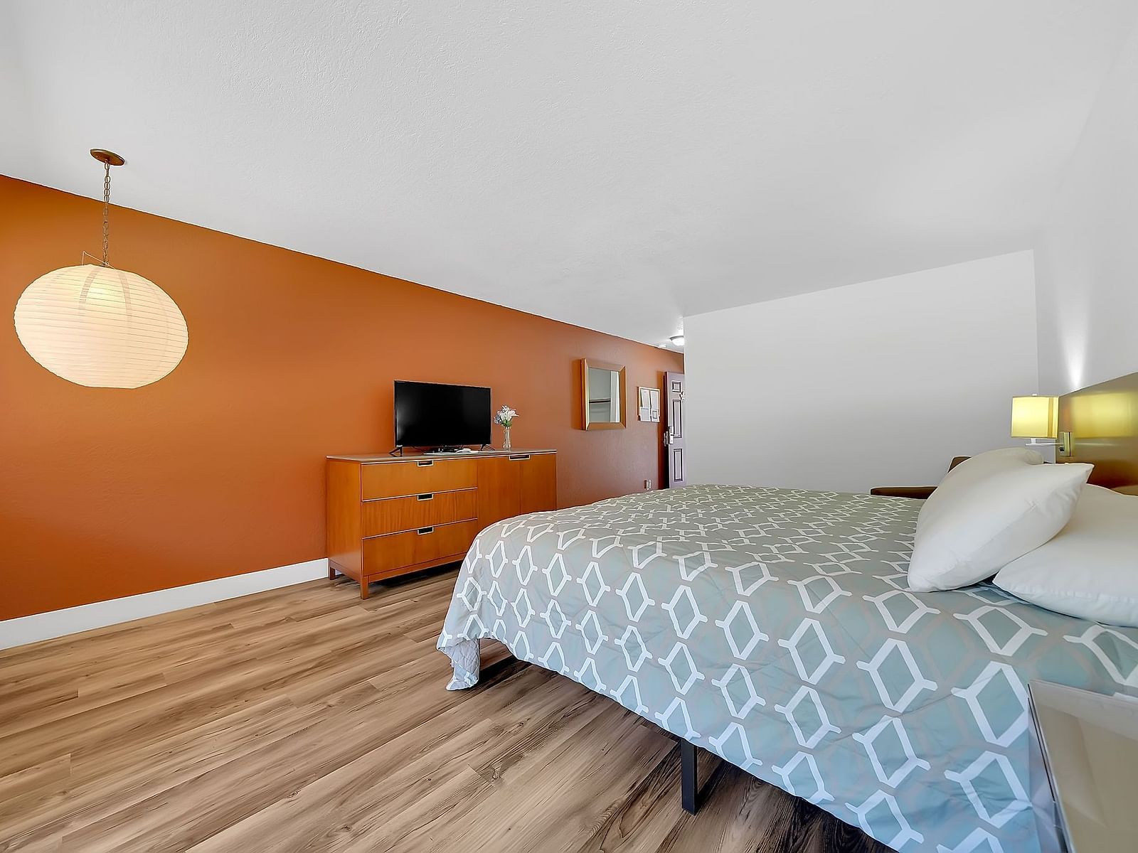 A view of a room at Amador Hotel with a double bed and a television.