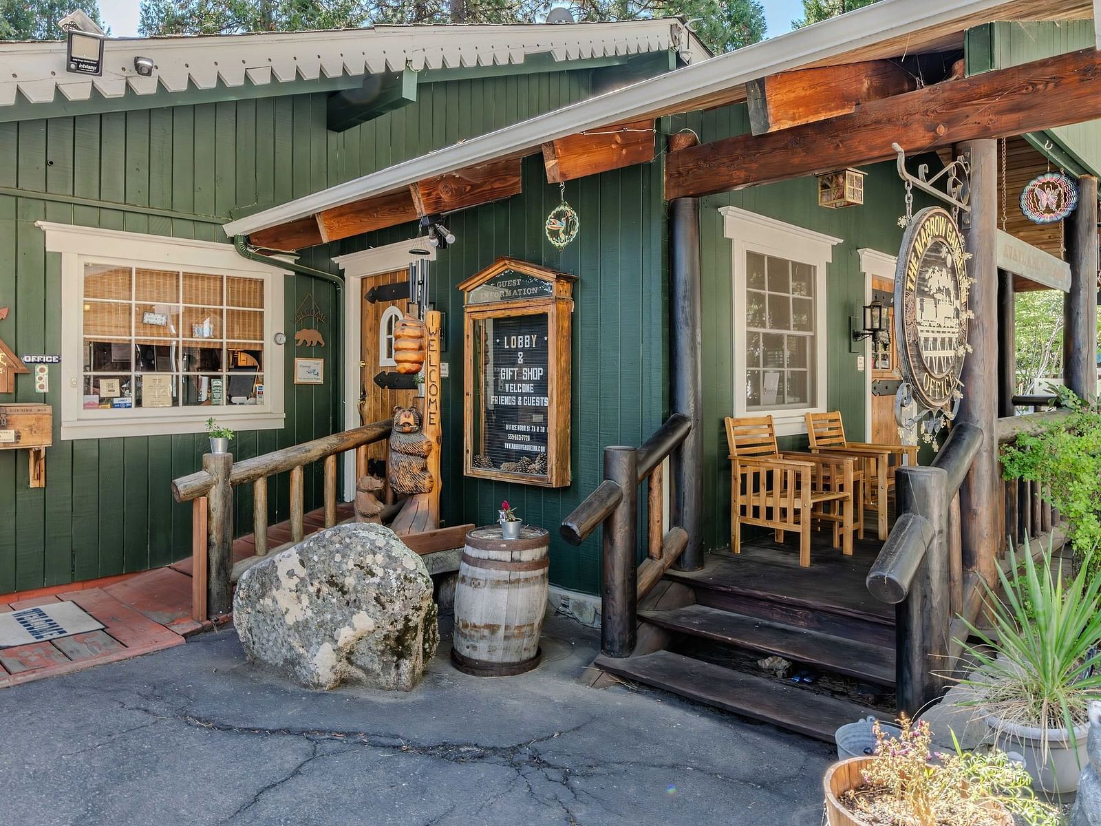 A view of a wooden cabin with pastel green exteriors at Narrow Gauge Inn