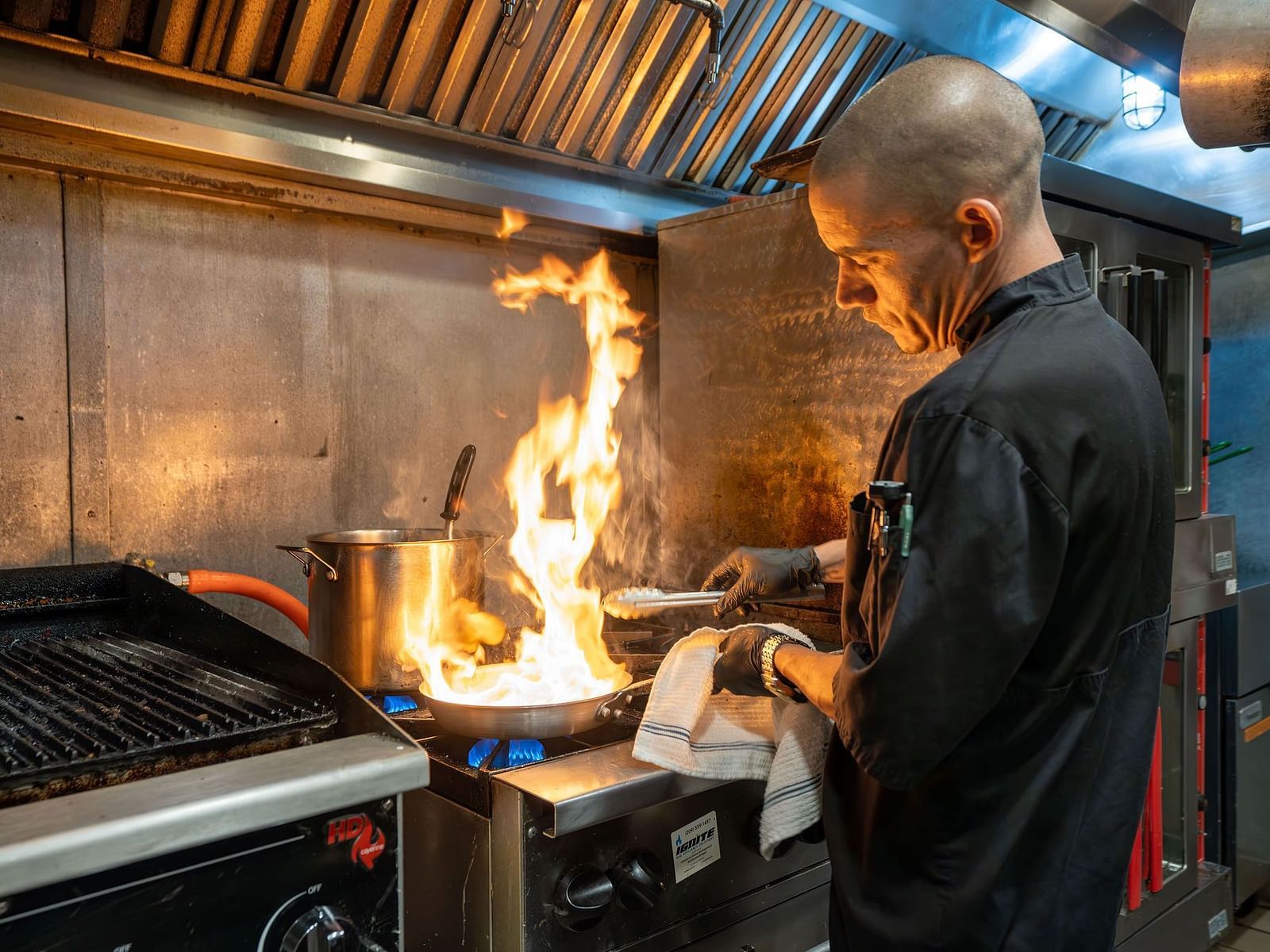 A chef cooking at the station in a commercial kitchen