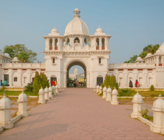 A grand palace entrance with domed gateways and landscaped grounds - Polo Hotel Agartala