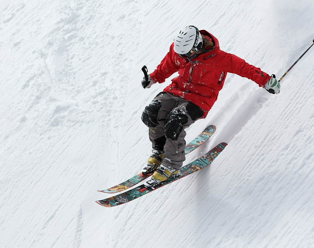 Picture of a person skiing down a snowy slope .