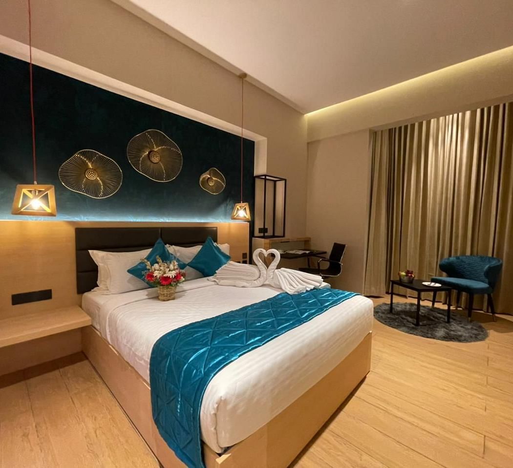 Double bed with blue sheets at Premium Room at Le Foliage by TGI, Bangalore