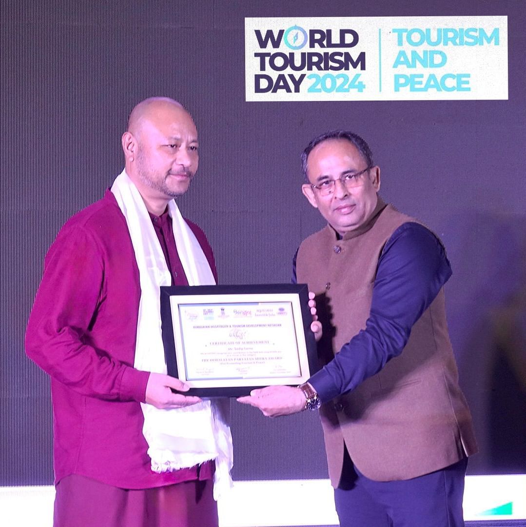 Man receiving an award at World Tourism Day 2024 event.