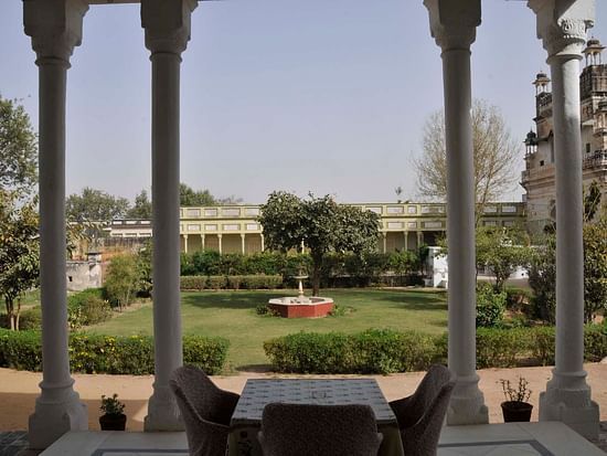 view of the lush lawn and water feature at The Piramal Haveli - 20th Century, Shekhavati