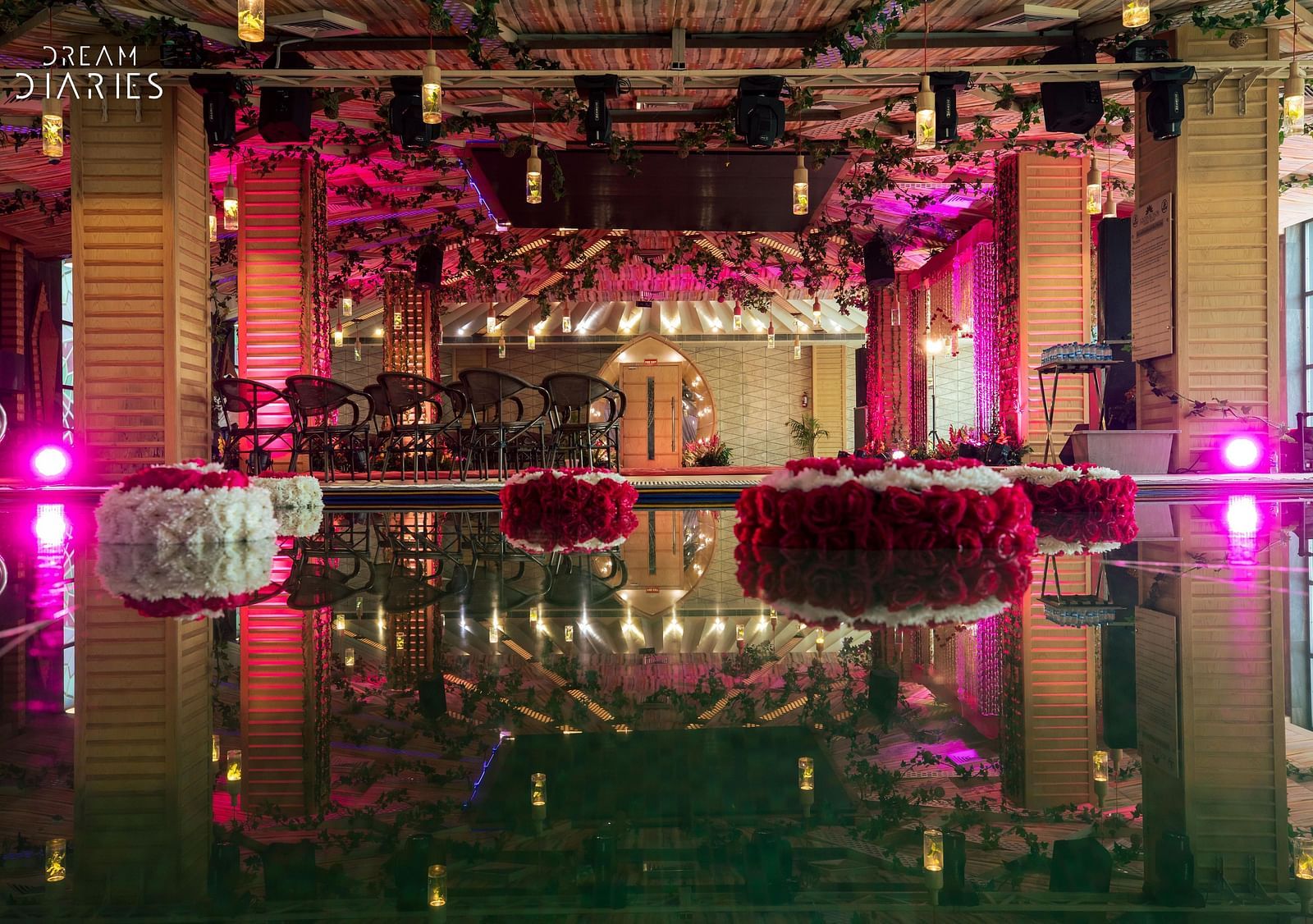 A well decorated banquet hall with seating arrangements and a dance floor - Golden Blossom Imperial resorts Lucknow