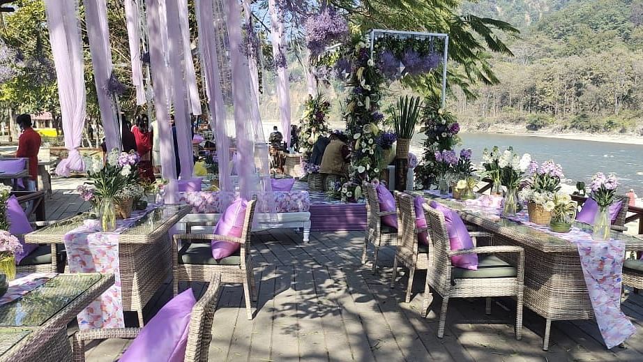  An image of a outdoor banquet hall with chairs and a stage decorated for destination wedding halls - Riverview Retreat, Corbett