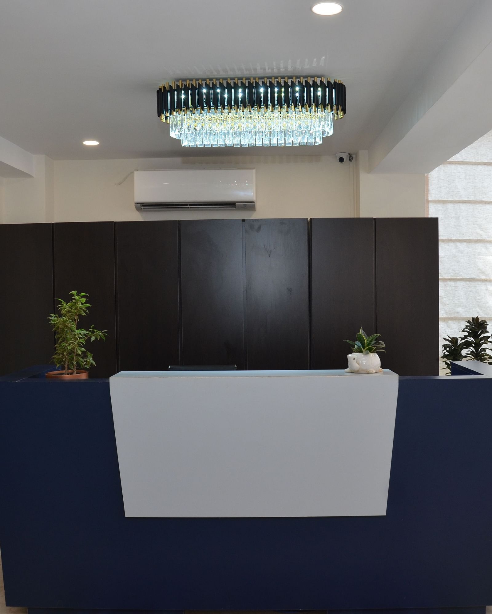 The brightly lit reception area of our hotel featuring a front desk - Lords Eco Inn Belagavi