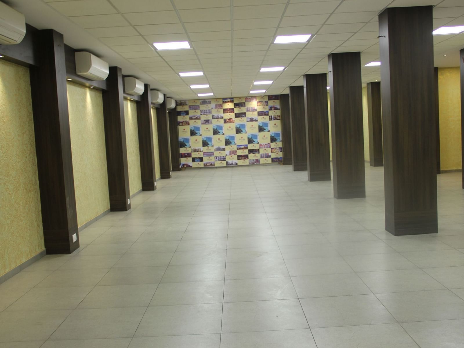 Spacious banquet hall with tiled flooring and decorative wall