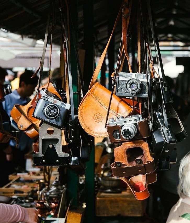 A rack displays a collection of hanging cameras