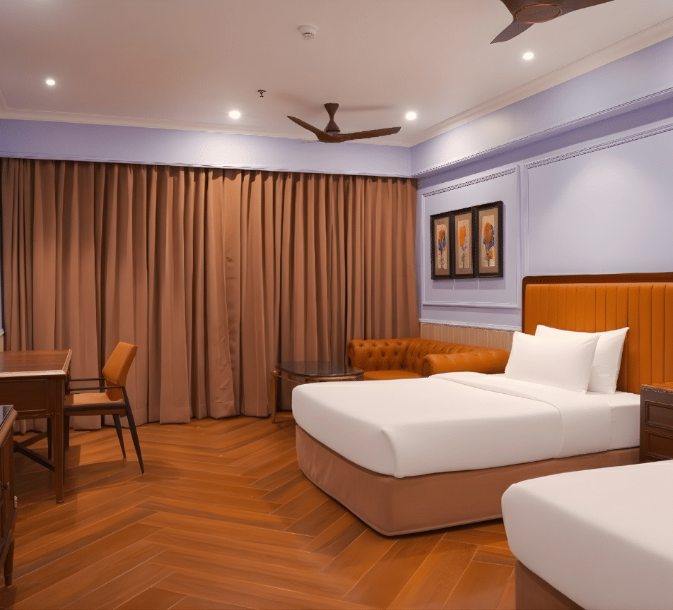 A contemporary twin bed room with a study desk, lounge chair, large curtains, framed wall art, wooden flooring and ceiling fan, ideal for relaxed stays at MAYFAIR Bay Resort, Paradeep.