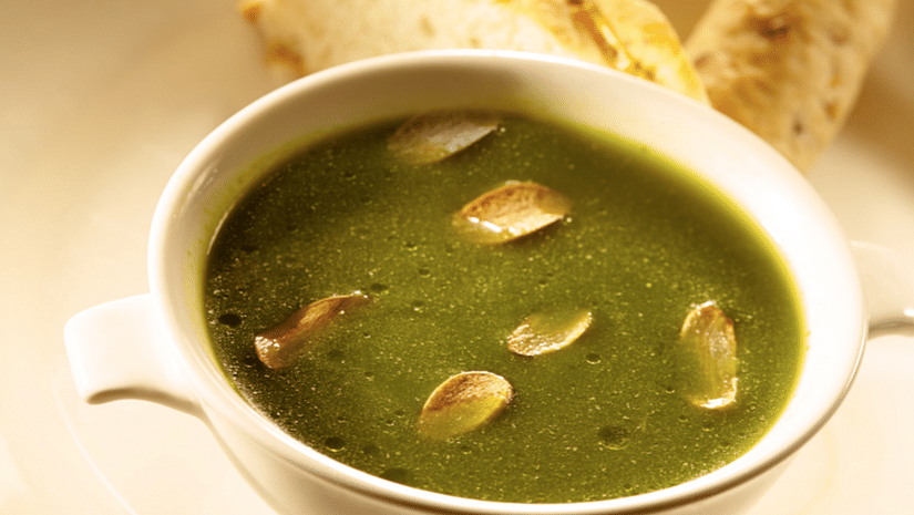 A bowl of green soup with dry fruits - Hablis Hotel, Chennai