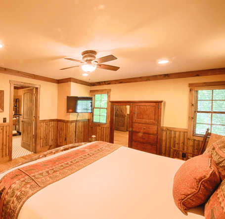 corner view of a bedroom with rustic wooden interiors overlooking a plush double bed - Historic Tapoco Lodge