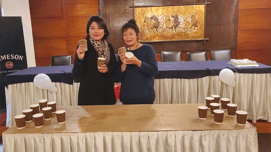 people posing with cups 498