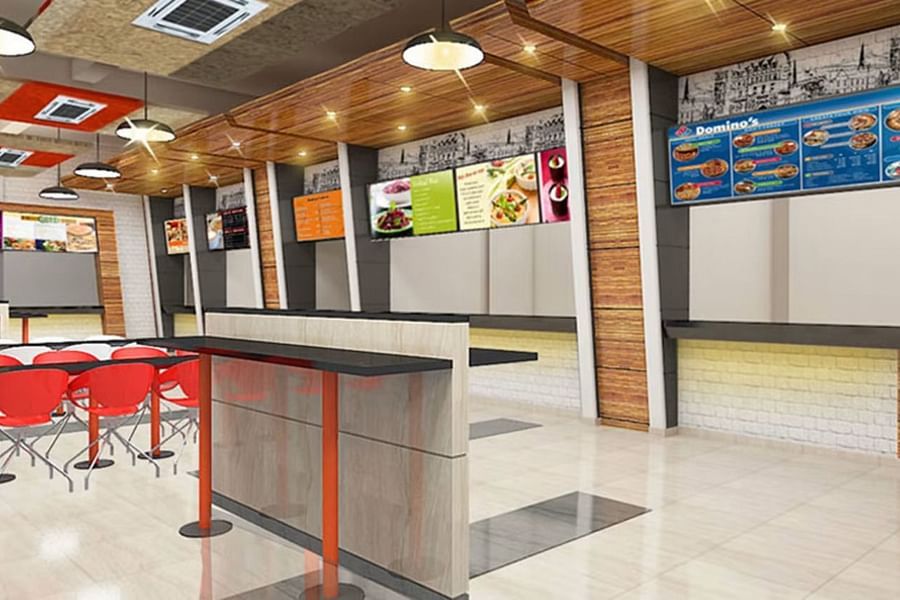 alt-text Interior of a hotel food court with red seating and a mix of wood and tile textures.